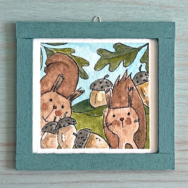 A watercolor mini painting depicting two squirrels and some acorns.